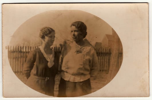 AUSTRIA-HUNGARY - CIRCA 1915: Vintage photo shows two women - mother and daughter. Retro black and white photography with sepia effect. Photo was taken in Austro-Hungarian Empire or also Austro-Hungarian Monarchy. Circa 1930s.