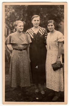 THE CZECHOSLOVAK REPUBLIC - CIRCA 1940s: Vintage photo shows three mature woman poses outdoors. Retro black and white photography. Circa 1940s.