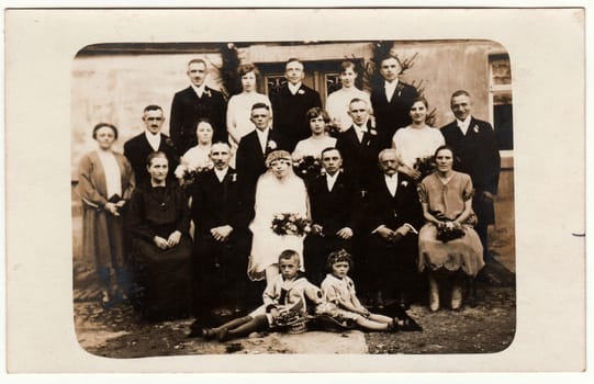 THE CZECHOSLOVAK REPUBLIC - CIRCA 1920s: Vintage photo shows newlyweds, bridesmaids, bridesmen and other wedding guests. Retro black and white photography. Circa 1920s.