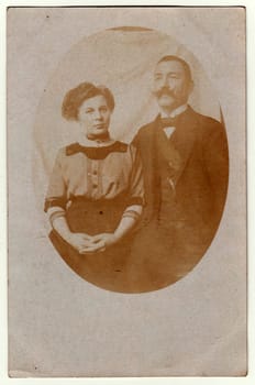 AUSTRIA-HUNGARY - CIRCA 1915: Vintage photo shows women and man - married couple. Retro black and white photography with sepia effect. Photo was taken in Austro-Hungarian Empire or also Austro-Hungarian Monarchy