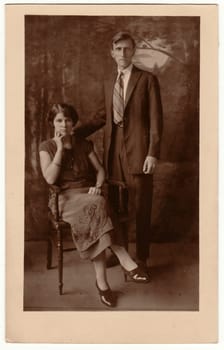 RIO BRANCO, URUGUAY - 1926: Vintage photo shows a young couple. Retro black and white studio photography. Vintage photo shows the road in the village. Retro black and white photography. Circa 1930s.