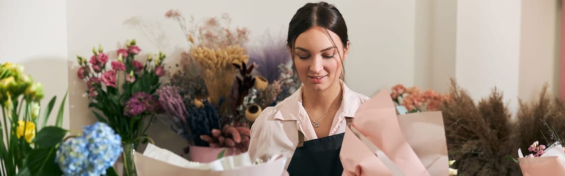 happy professional woman is working in flower shop