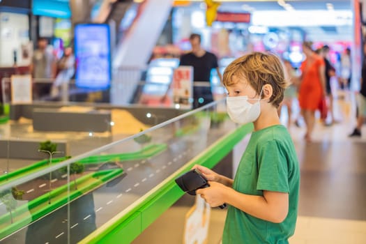 Adorable cute little child playing with toy on remote control, in the mall. Happy kid boy having fun. Leisure, lifestyle for kids concept.