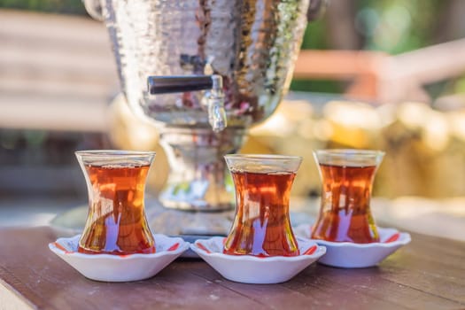 Drinking Traditional Turkish Tea with Turkish tea cup and copper tea pot.