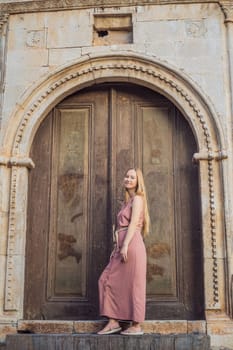 Woman tourist in Old town Kaleici in Antalya. Turkiye. Panoramic view of Antalya Old Town port, Taurus mountains and Mediterrranean Sea, Turkey.