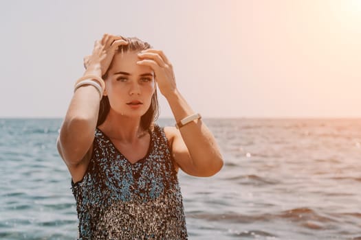 Woman travel sea. Young Happy woman in a long red dress posing on a beach near the sea on background of volcanic rocks, like in Iceland, sharing travel adventure journey