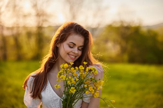 portrait of a happy woman with a bouquet of yellow flowers illuminated from the back by the setting sun. High quality photo