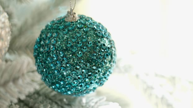 Bright blue christmas tree ball with shiny stones closeup. New Year decor concept