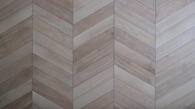 Wooden floor with parquet in shape of tree closeup background. Laying laminates concept