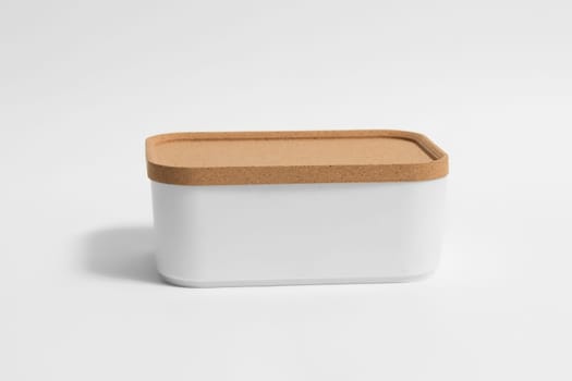 White plastic interior container organizer with cork wood lid isolated on white background.