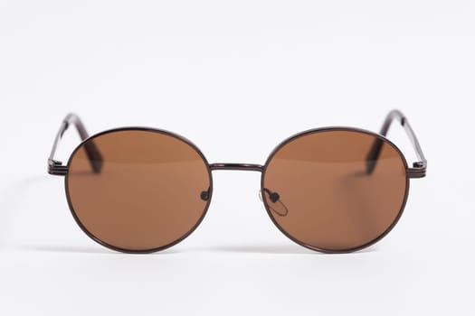 Brown sunglasses isolated on white background close-up, fashionable trendy stylish accessory.