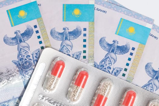 Top view on blister with medical pills drug with Tenge Kazakhstan money.