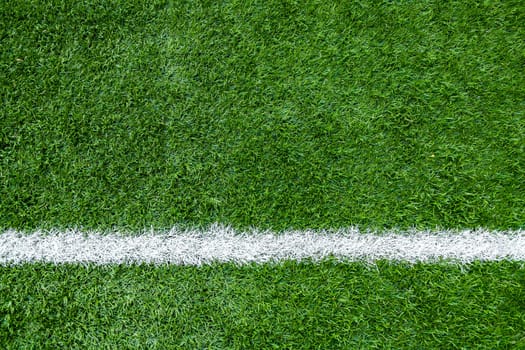 White stripe markings on the green grass of the sports field.