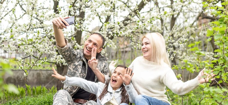 Handsome soldier reunited with family on a sunny day