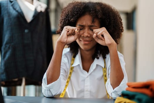 young teen african american fashion designer stylish burnout working at fashion Business studio.