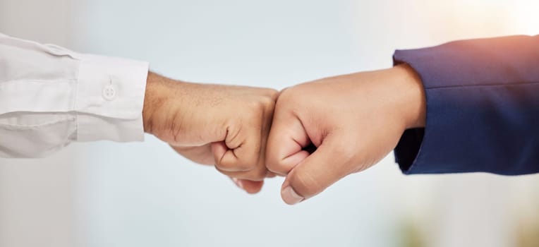 Business people, hands and fist bump in teamwork agreement for good job, winning or success at office. Employees touching hands or fists for team support, win or collaboration together at workplace.