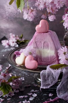 sweet curd orthodox easter on a background of purple sakura and heart-shaped macaroons, traditional food, High quality photo