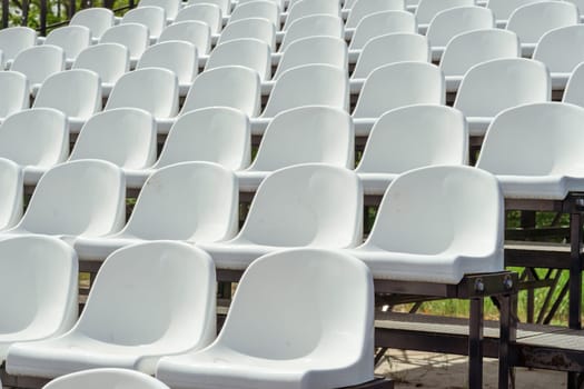 Seats of tribune on sport stadium. Concept of fans, chairs for audience, cultural environment concept. mpty seats, modern stadium