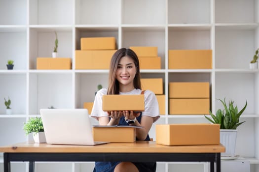 Starting Small business entrepreneur SME freelance, Portrait young woman working at home office, BOX, smartphone, laptop, online, marketing, packaging, delivery, b2b, SME, e-commerce concept