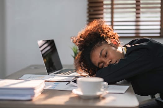 tired business woman sleepy and bored from sitting at a desk for a long time and has office syndrome..