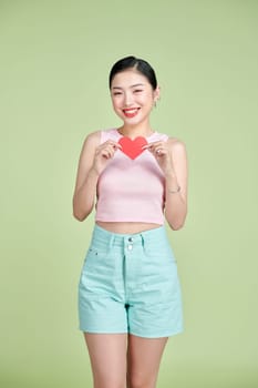 Love symbol. Beautiful girl holding a heart, office manager concept shot