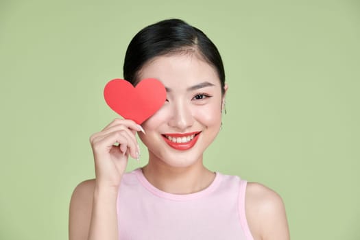 young smile woman hold red heart.
