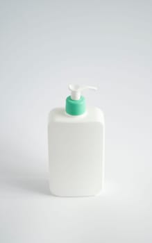 Large white plastic bottle with pump dispenser as a liquid container for gel, lotion, cream, shampoo, bath foam on white background