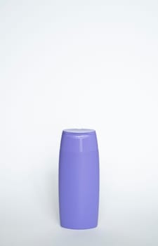 Violet plastic bottle of body care and beauty products. Studio photography of plastic bottle for shampoo, shower gel, creme isolated on white background