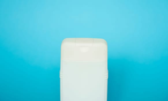 White square bottle for liquid soap, shampoo, gel on blue background