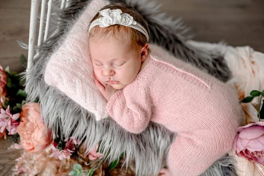 Newborn baby girl sleeping in tiny bed with peony flowers decoration. Cute infant child kid napping floral spring portrait