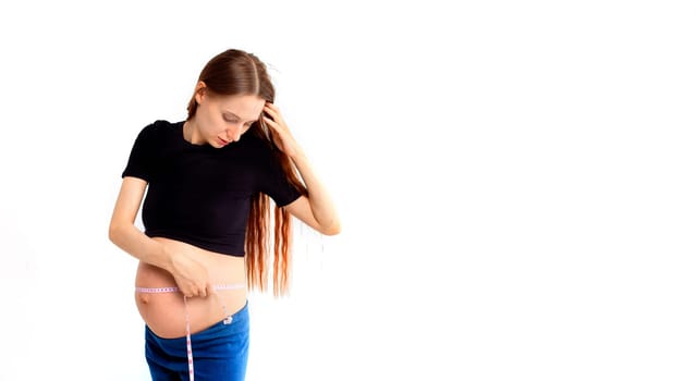 Pregnant woman measuring stomach with measuring tape. Banner with copy space