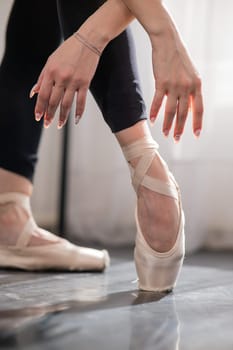 Close-up of the legs and arms of a ballerina