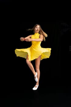 portrait of a teenage ballerina in a suit on a black background. High quality photo