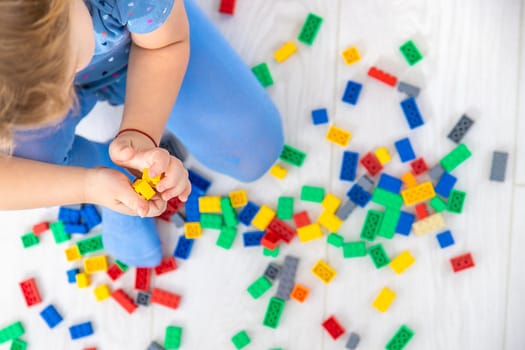 The child plays as a constructor. Selective focus. Kid.