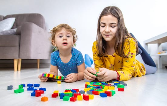 The child plays as a constructor. Selective focus. Kid.