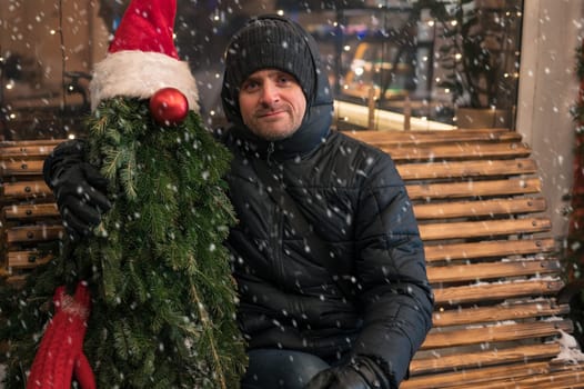 Man with fir tree decorated mannequin. Xmas holidays, New Year or Christmas concept