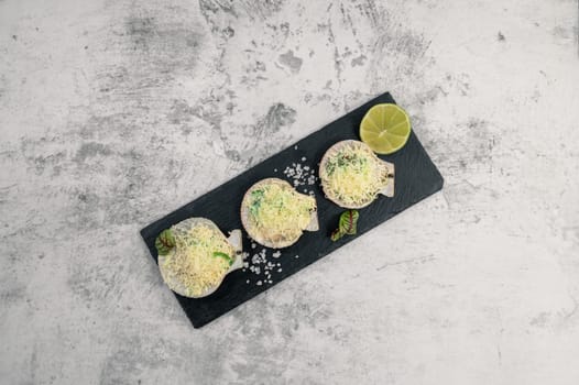 Delicacy roasted scallops with cheese spices and chuka algae