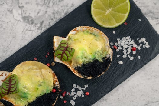 Delicacy roasted scallops with cheese spices and chuka algae