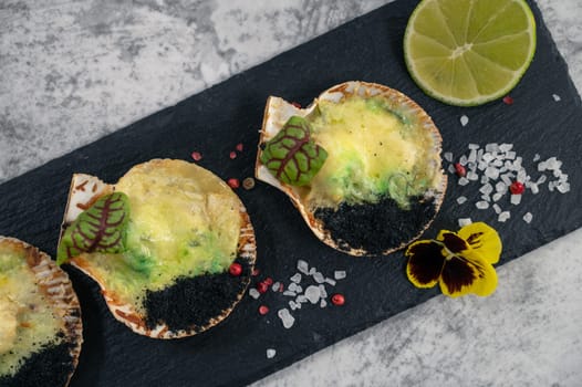 Delicacy roasted scallops with cheese spices and chuka algae