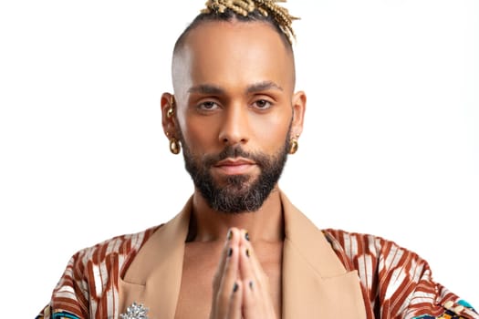 Afro-american gay man portrait with prayer hands call for peace and tranquility reflecting on his spiritual connection and seeking inner peace. The rights of sexual minorities