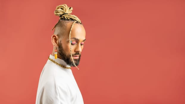 Trendy black latin gay man in white clothes look down isolated on pink background studio portrait People lifestyle fashion lgbtq concept