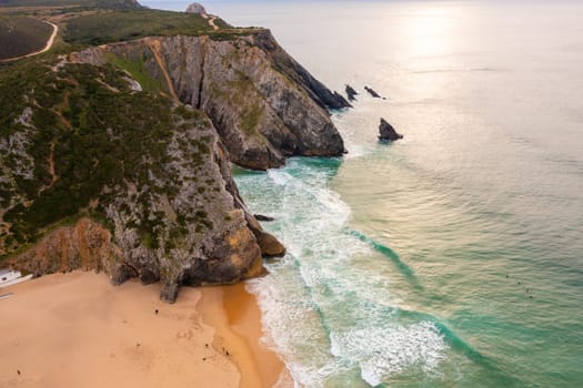 Aerial Drone View of Portugal Atlantic Coast at Lisbon, a Dramatic Rugged Rocky Coastline with Waves Crashing and Breaking Against Rocks at Sunrise, Sintra, Praia da Adraga beach
