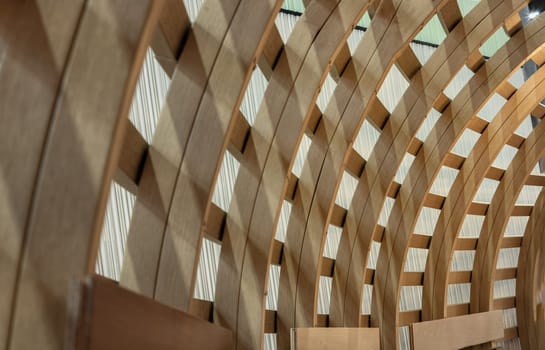 The Interior of Curved Diagonal Lines are made of the Wooden Composite with the Facade Design Architecture. Structure Perspective View of Softwood Curved Pergola. Sawn Arches, Design Architecture, Selective focus.