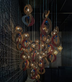 Bangkok,Thai - Apr 29, 2022 : Softly shining hanged  lamps with Braided Colorful Ropes, which means in Chinese Lucky Number Eight with dark background. Beautiful decor for the interior, 8 infinity unlimited lucky signs concept, No focus, specifically.
