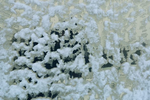 Abstract background from a window not evenly covered with snow.