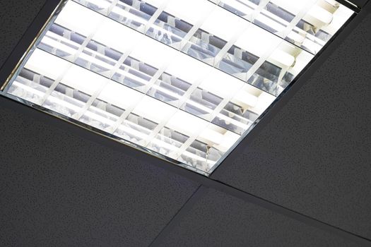 Modern white square form lamp in the ceiling close up