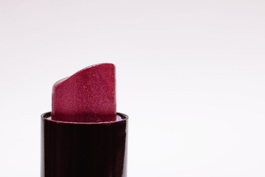 Red lipstick on a white background closeup, copy space