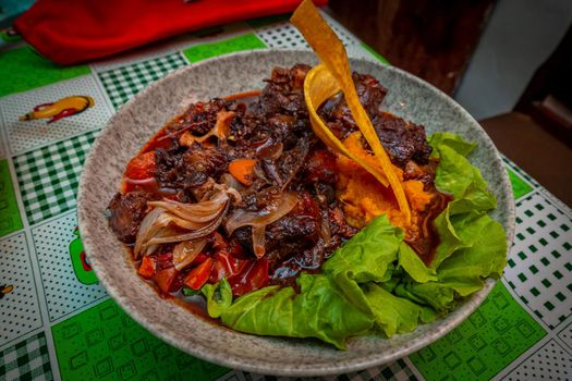 Rabo Encendido, Cuban Style Oxtail Stew over yam and lettuce,  served at restaurant Ivan Chef Justo, in Havana, Cuba