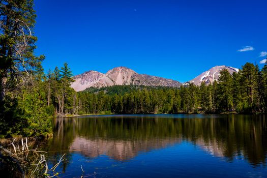 Chaos Crags and Lassen Peak reflected in Reflection Lake, Lassen Volcanic National Park, California