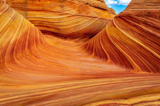 The Wave is a famous sandstone rock formation located in Coyote Buttes, Arizona, known for its colorful, undulating forms